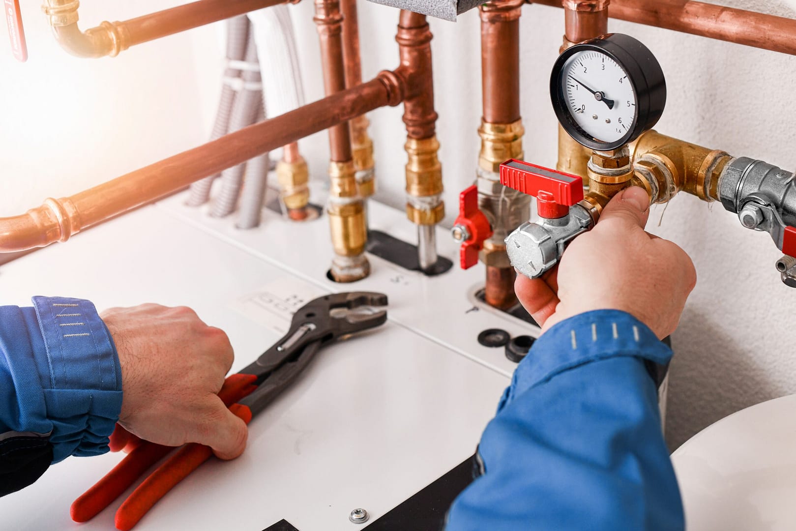 Plumber showing how to use a water pressure gauge in a residential setup.